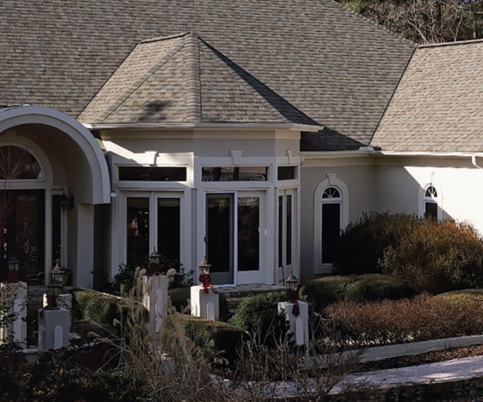 Certainteed-certified roofers accomplish roofing repairs on a brick home.