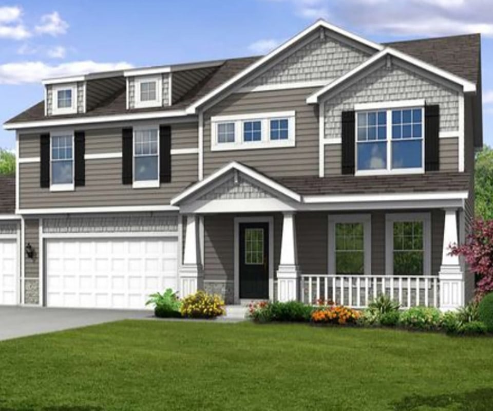 A house with two car garage, sided with stormy gray siding. The porch has white rail, the yard is beautiful with landscaped orange and yellow flower beds. To get your own vinyl siding cost estimate, call 815-235-7766 or fill out our free estimate form below.